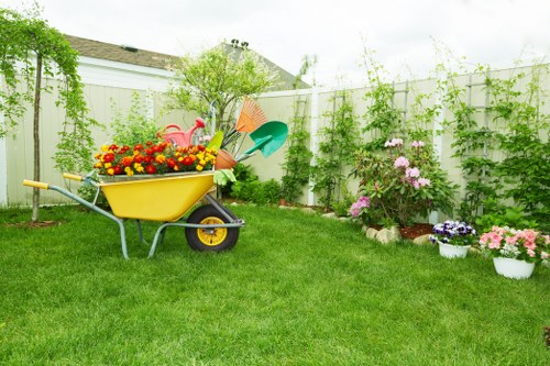 Team member with lawn mower preparing to start grass cutting